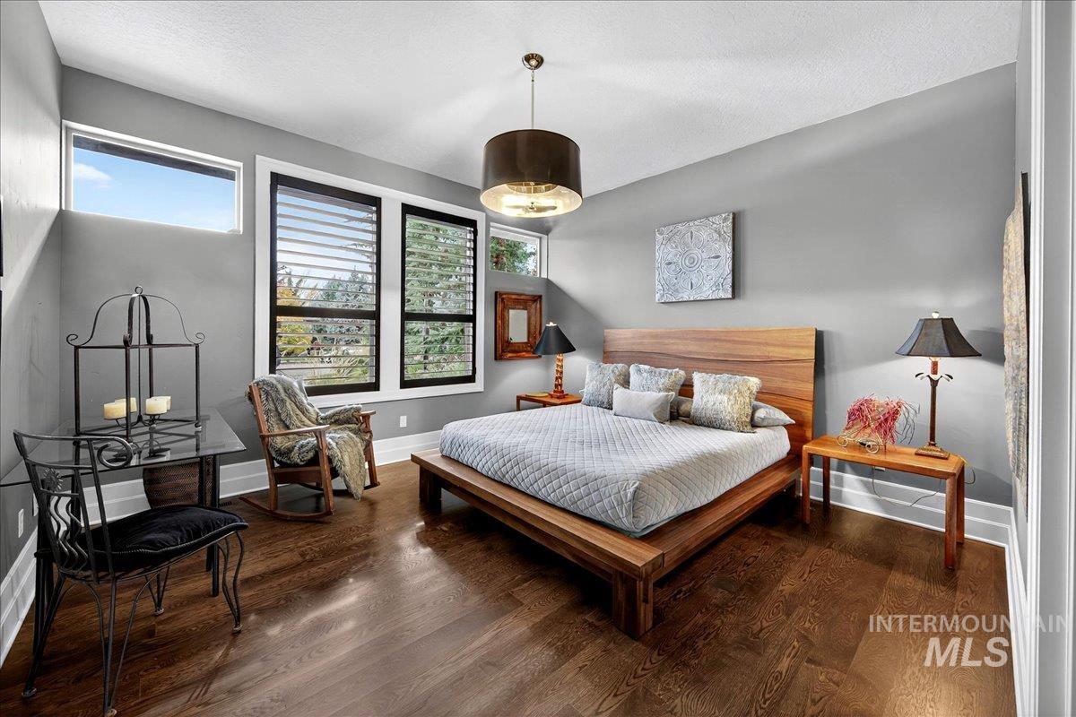 Bedroom featuring wood finished floors and a textured ceiling