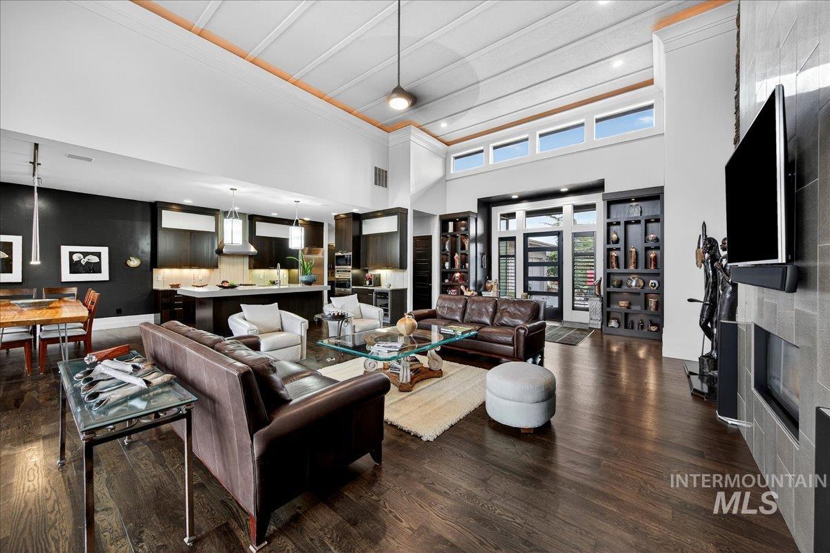 Living area featuring recessed lighting, dark wood finished floors, and a high ceiling