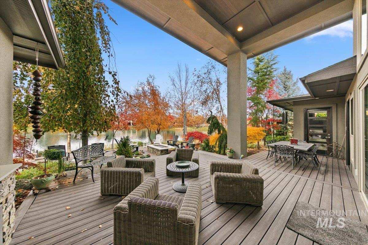 Deck with outdoor dining space, an outdoor living space, and a water view