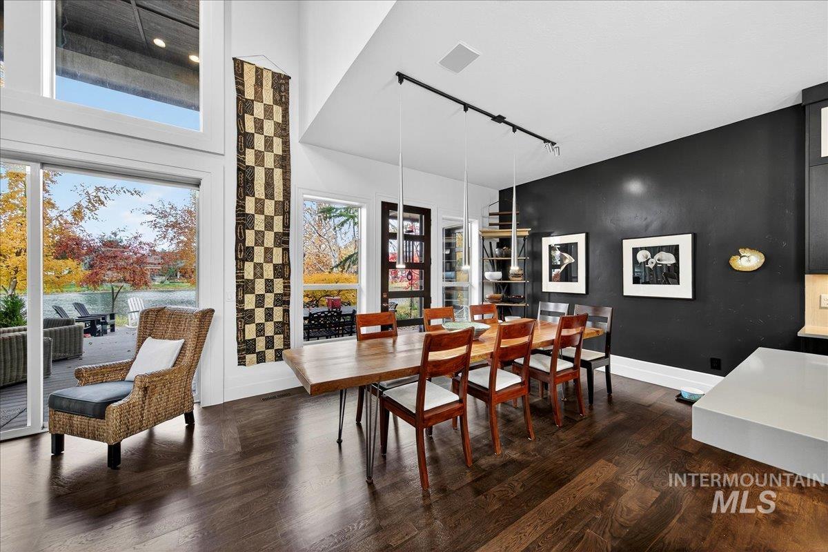 Dining room featuring rail lighting and dark wood-style floors