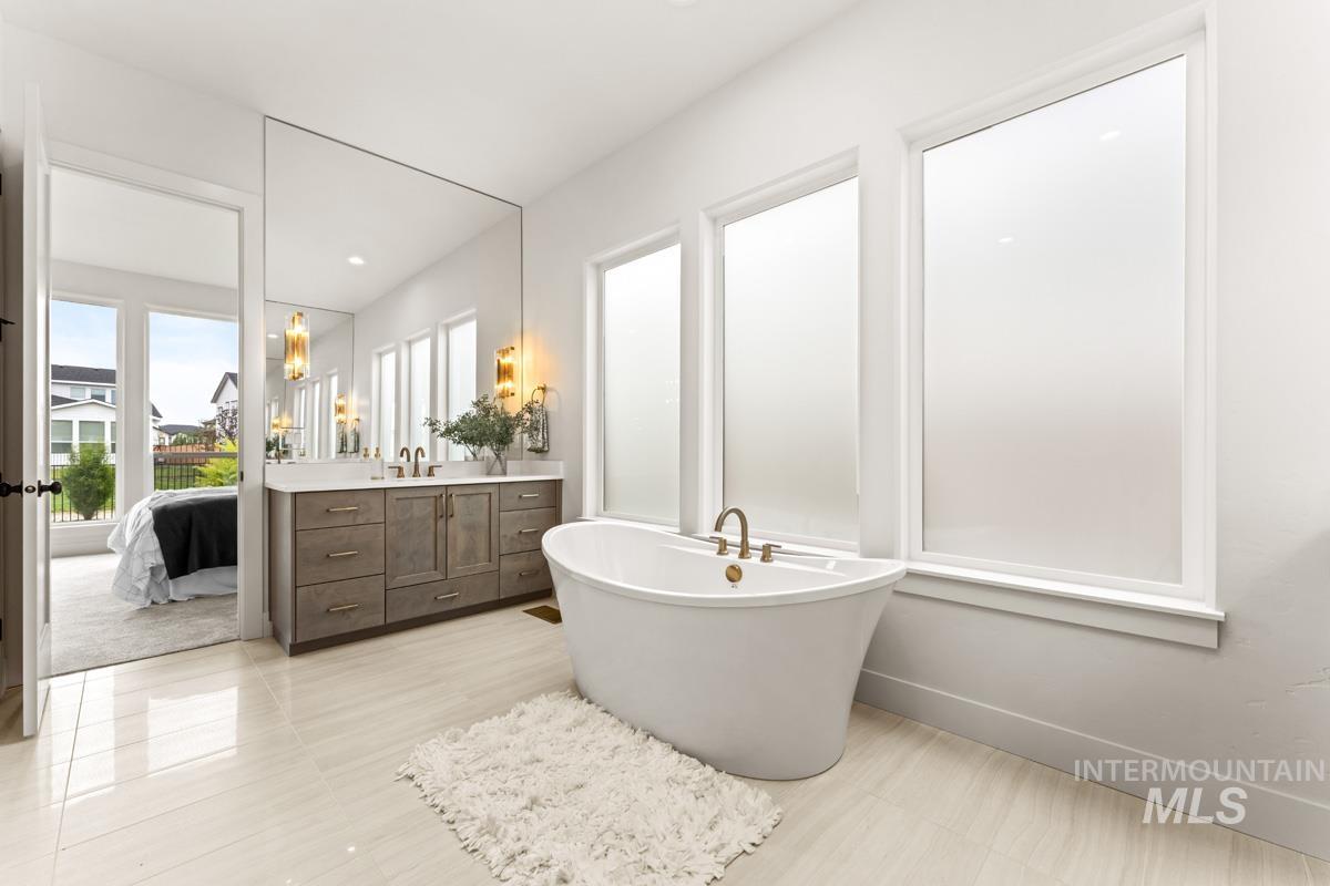 Freestanding soaking tub with brass fixtures
