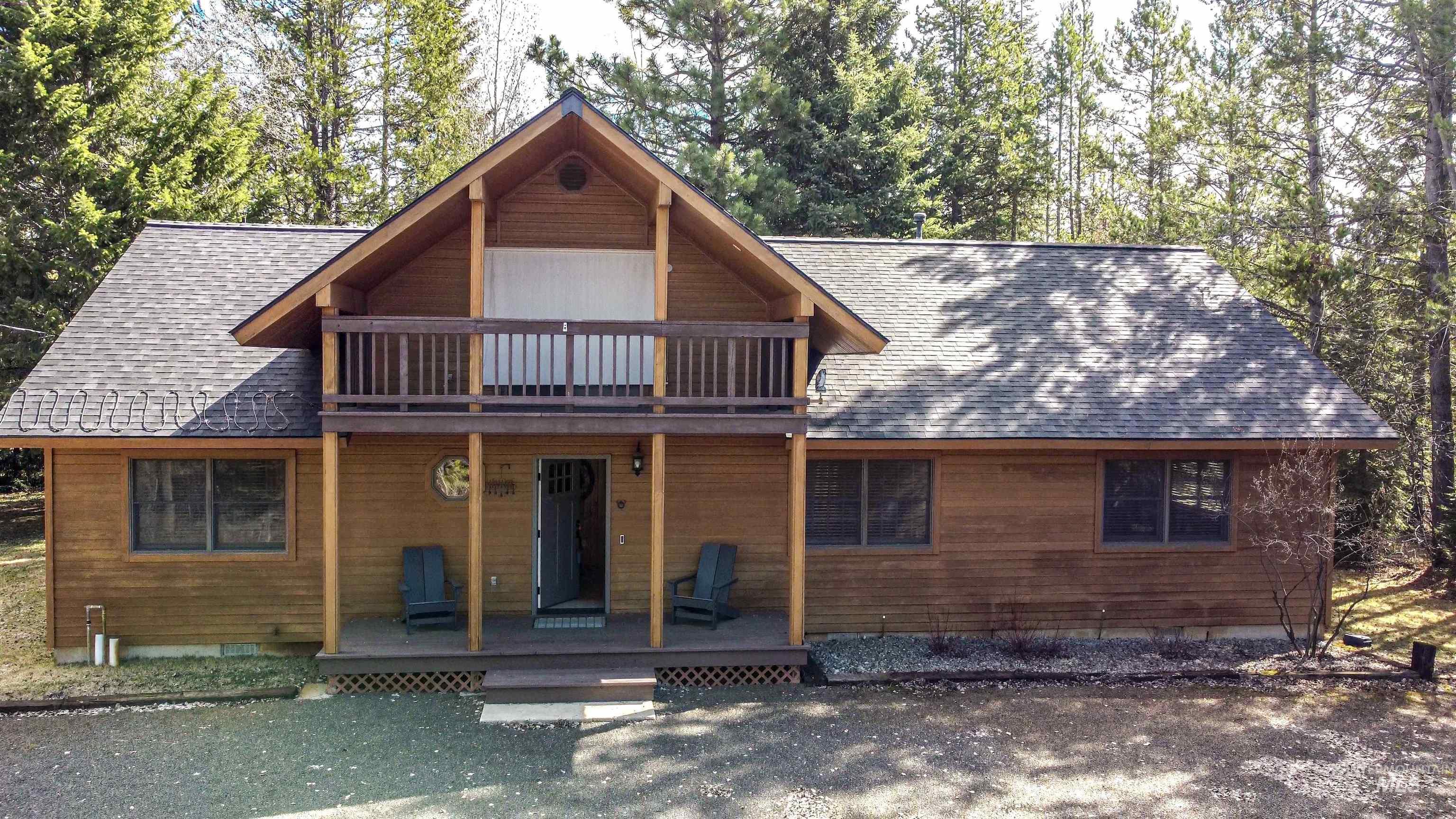 View of front of house with roof with shingles and covered porch