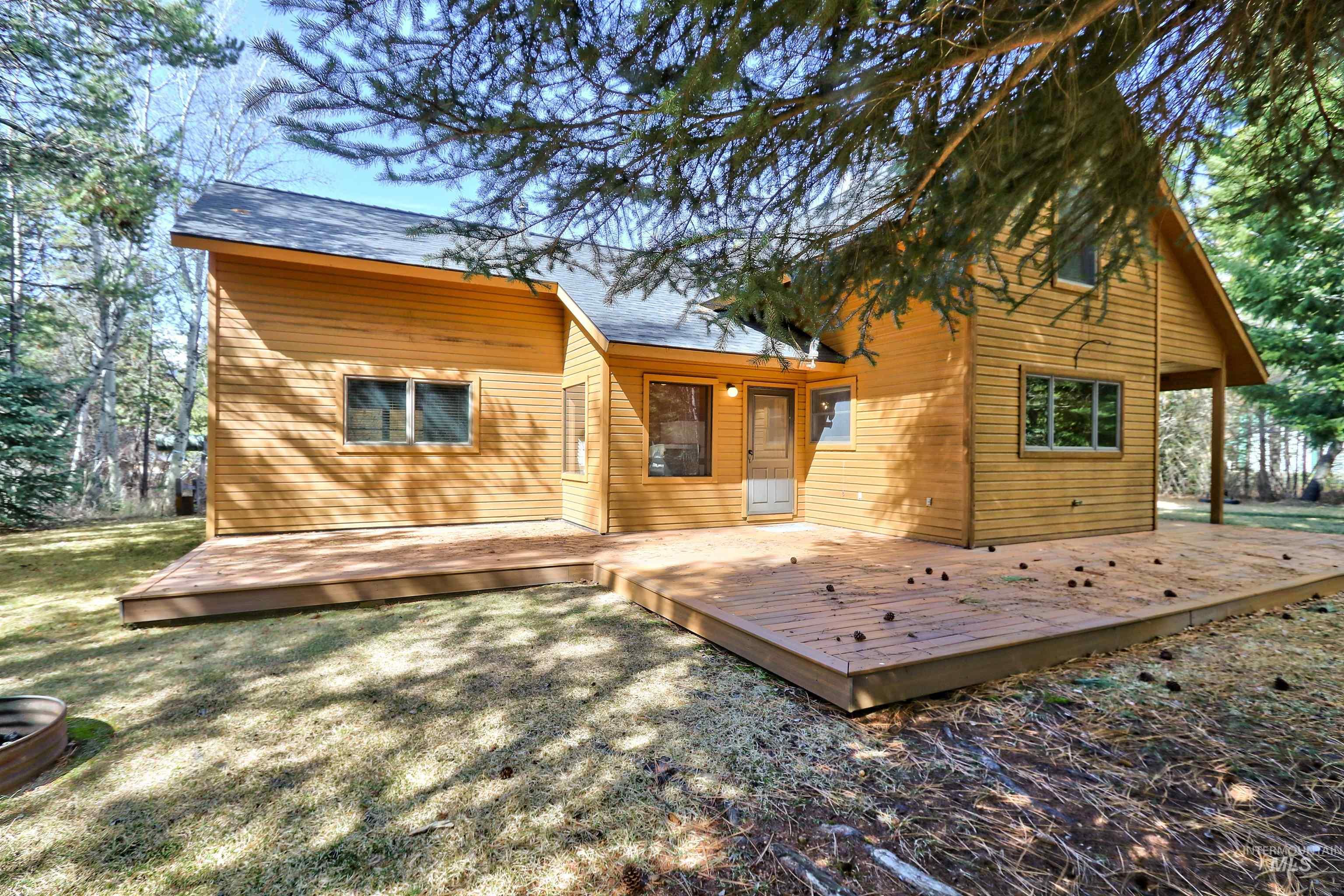 Back of house with a deck