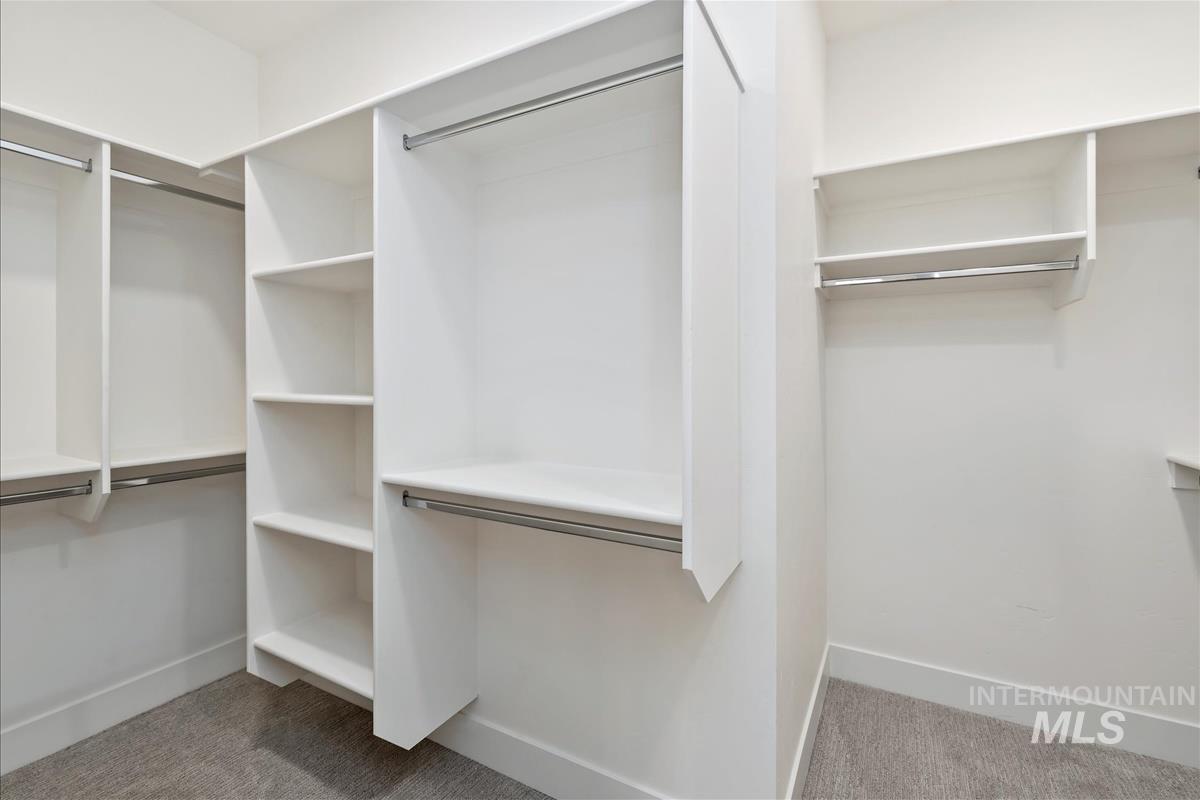 Walk in closet featuring light carpet