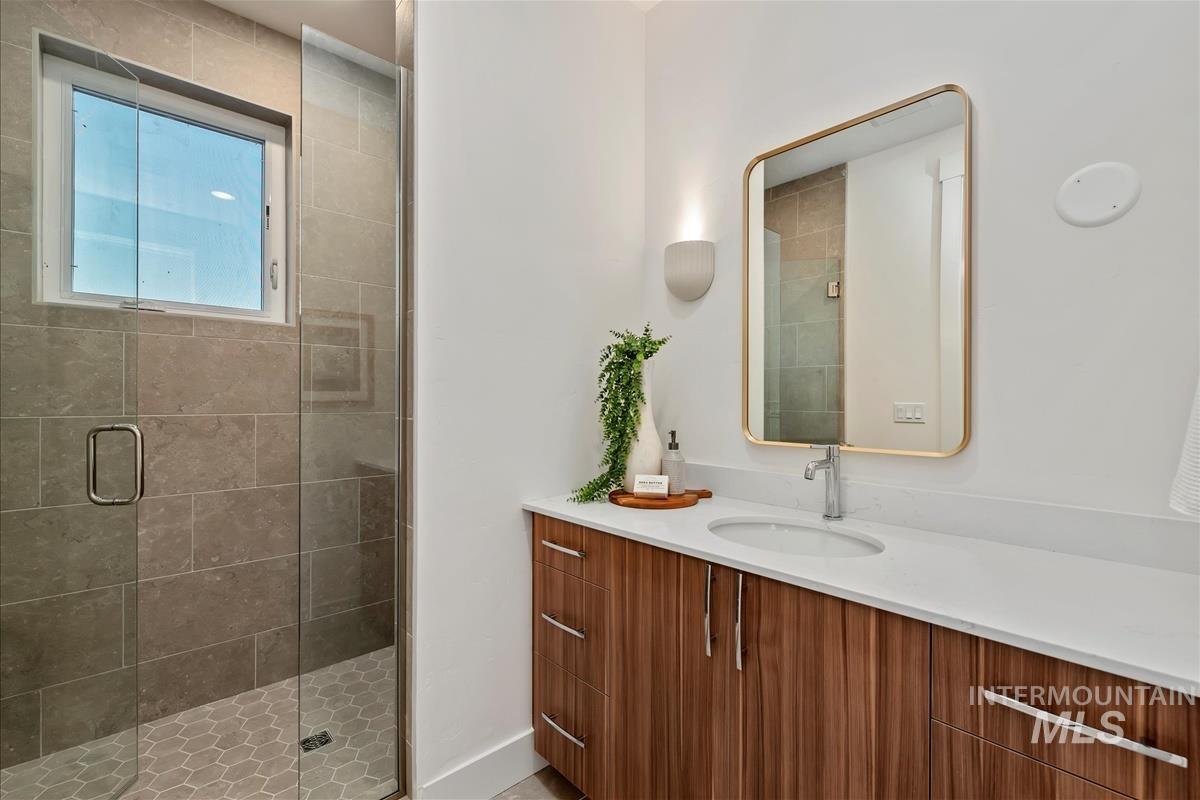 Full bathroom featuring vanity and a shower stall