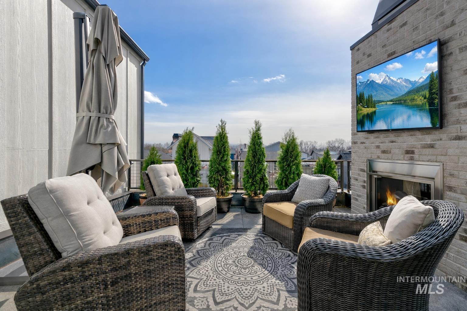 View of patio / terrace with an outdoor living space with a fireplace