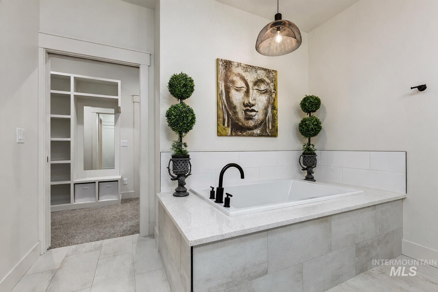 Full bath with baseboards and a bath