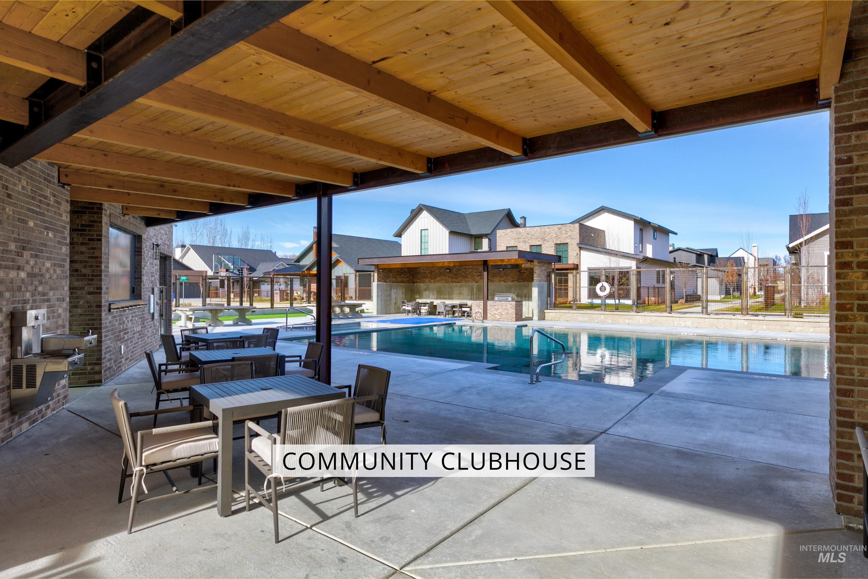 Community pool with a patio area and a residential view