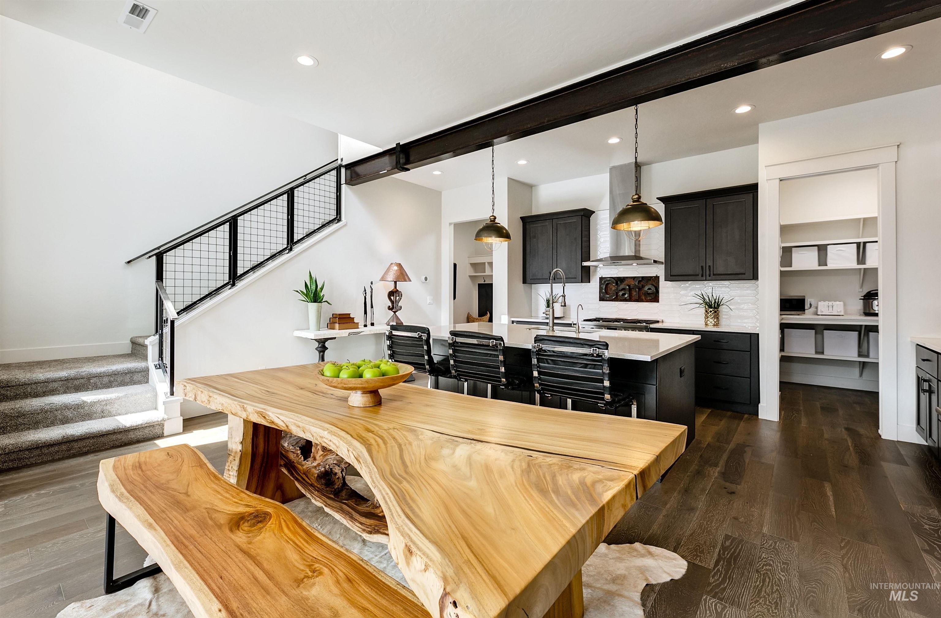 Dining area with dark wood-style flooring and recessed lighting