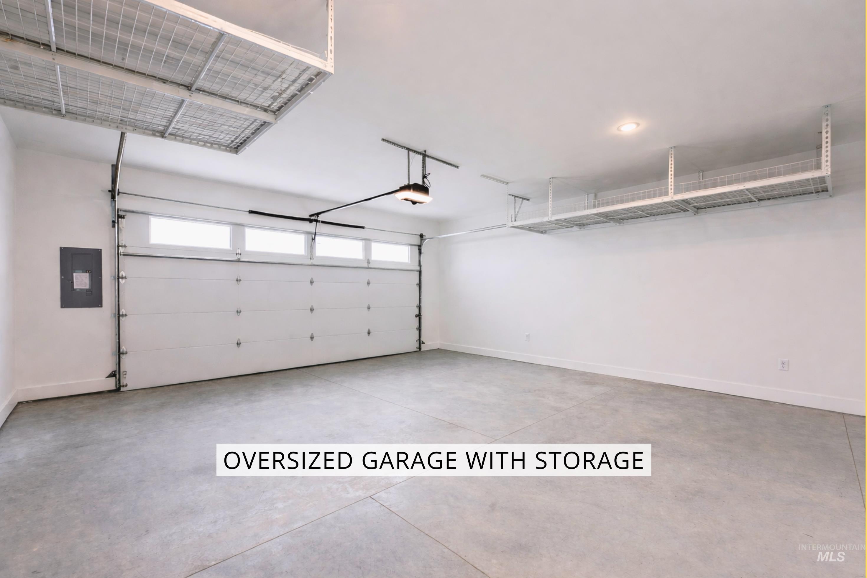Garage featuring electric panel and a garage door opener