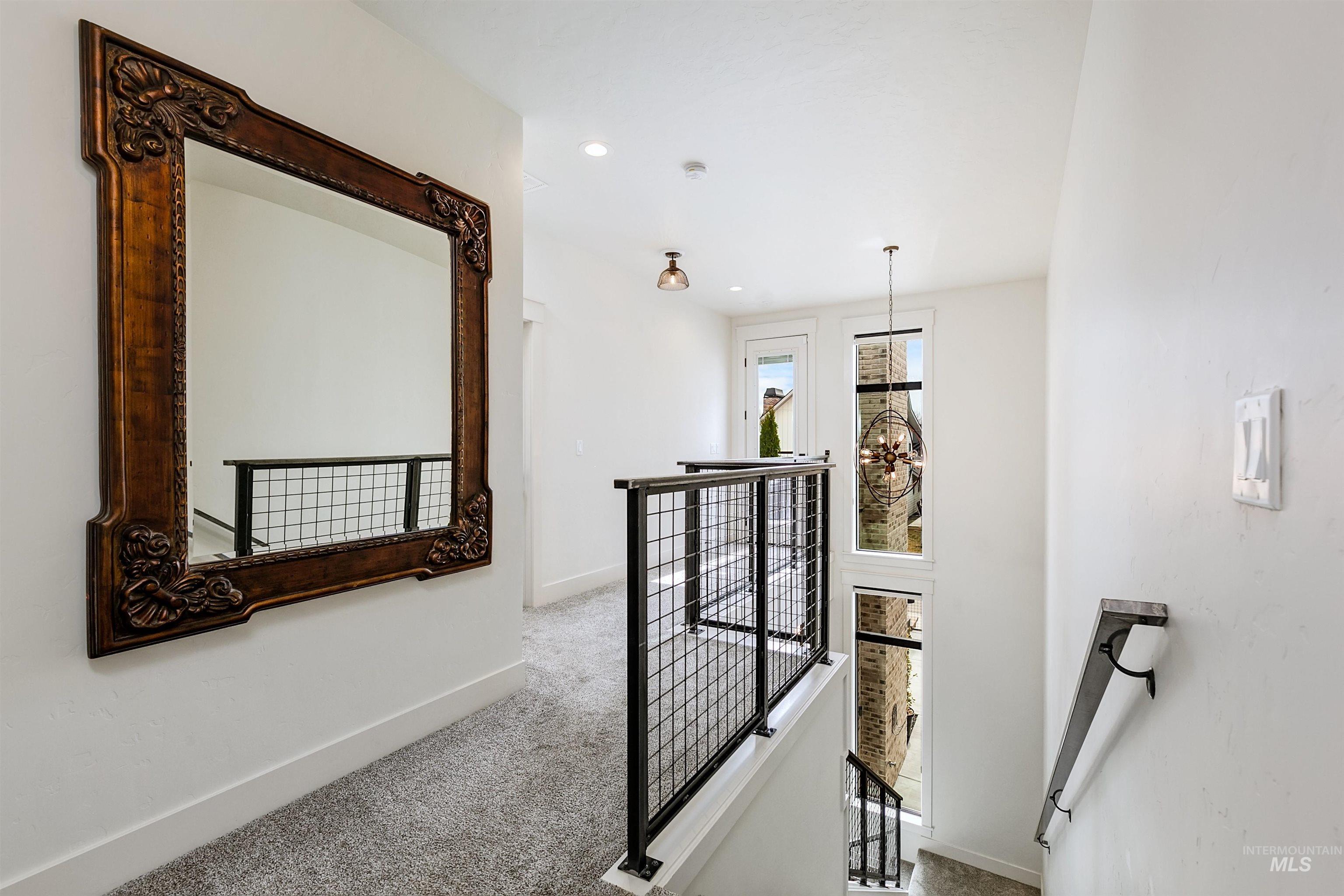 Corridor featuring an upstairs landing, carpet, and recessed lighting
