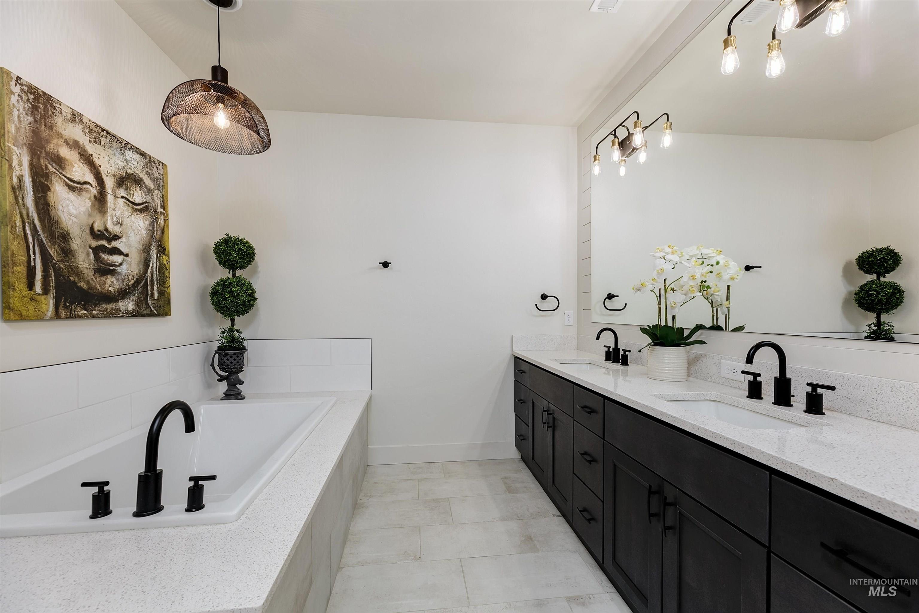 Full bathroom featuring double vanity and a garden tub