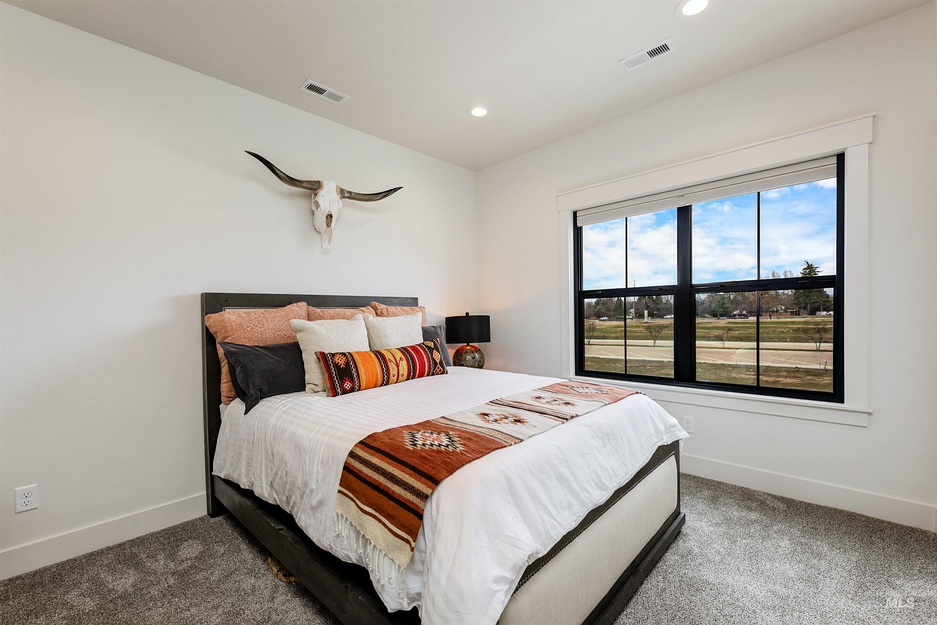 Carpeted bedroom with baseboards and recessed lighting