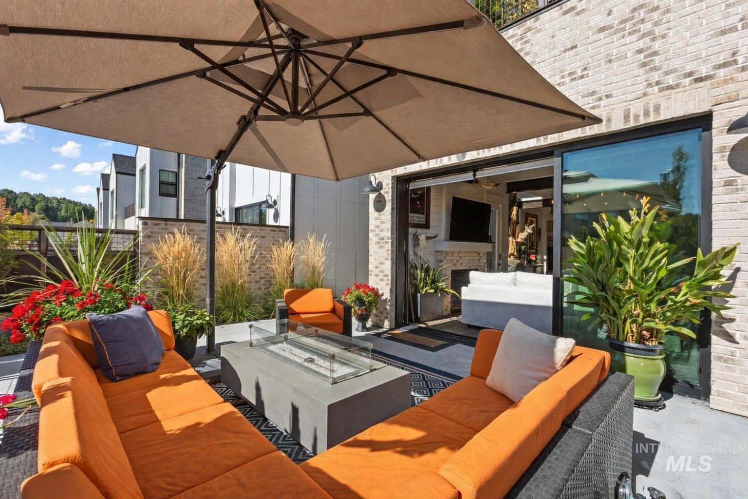 View of patio with an outdoor living space with a fire pit