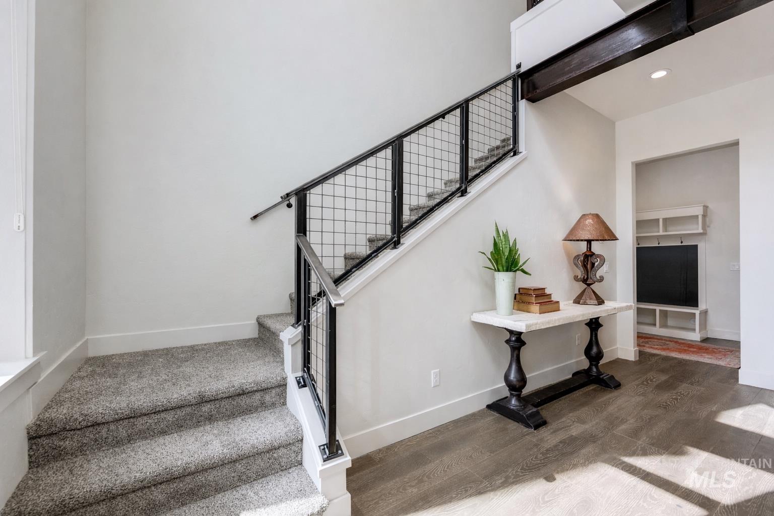 Staircase featuring wood finished floors and baseboards