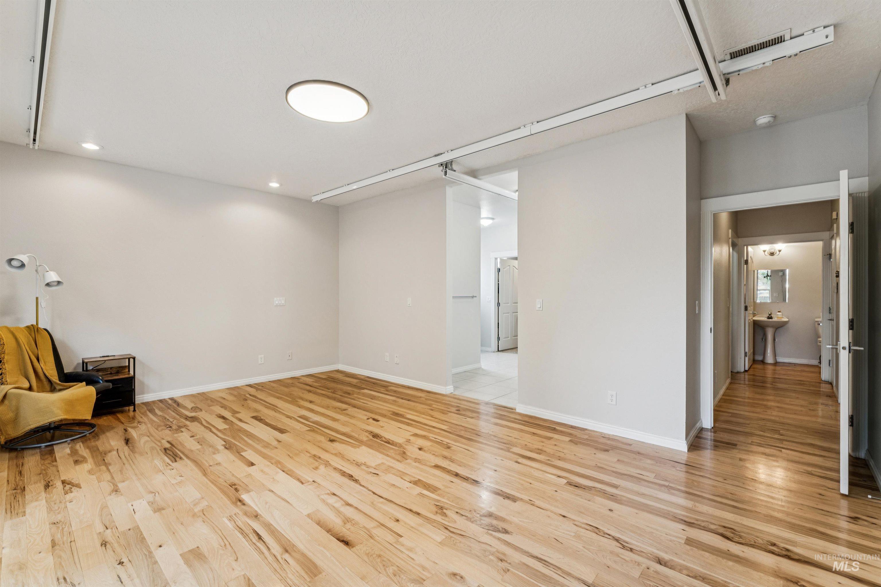 Featuring light wood finished floors and recessed lighting