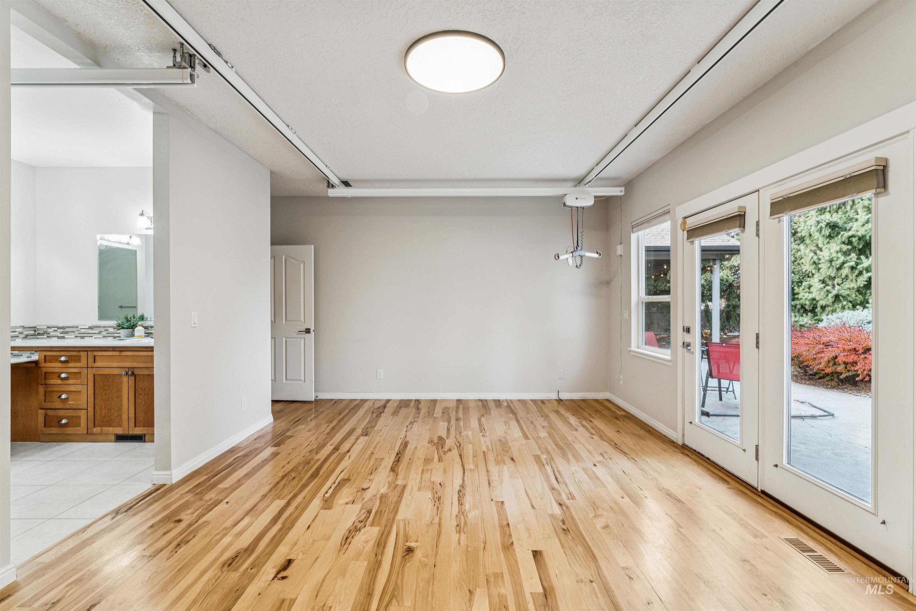 Light wood finished floors and a textured ceiling