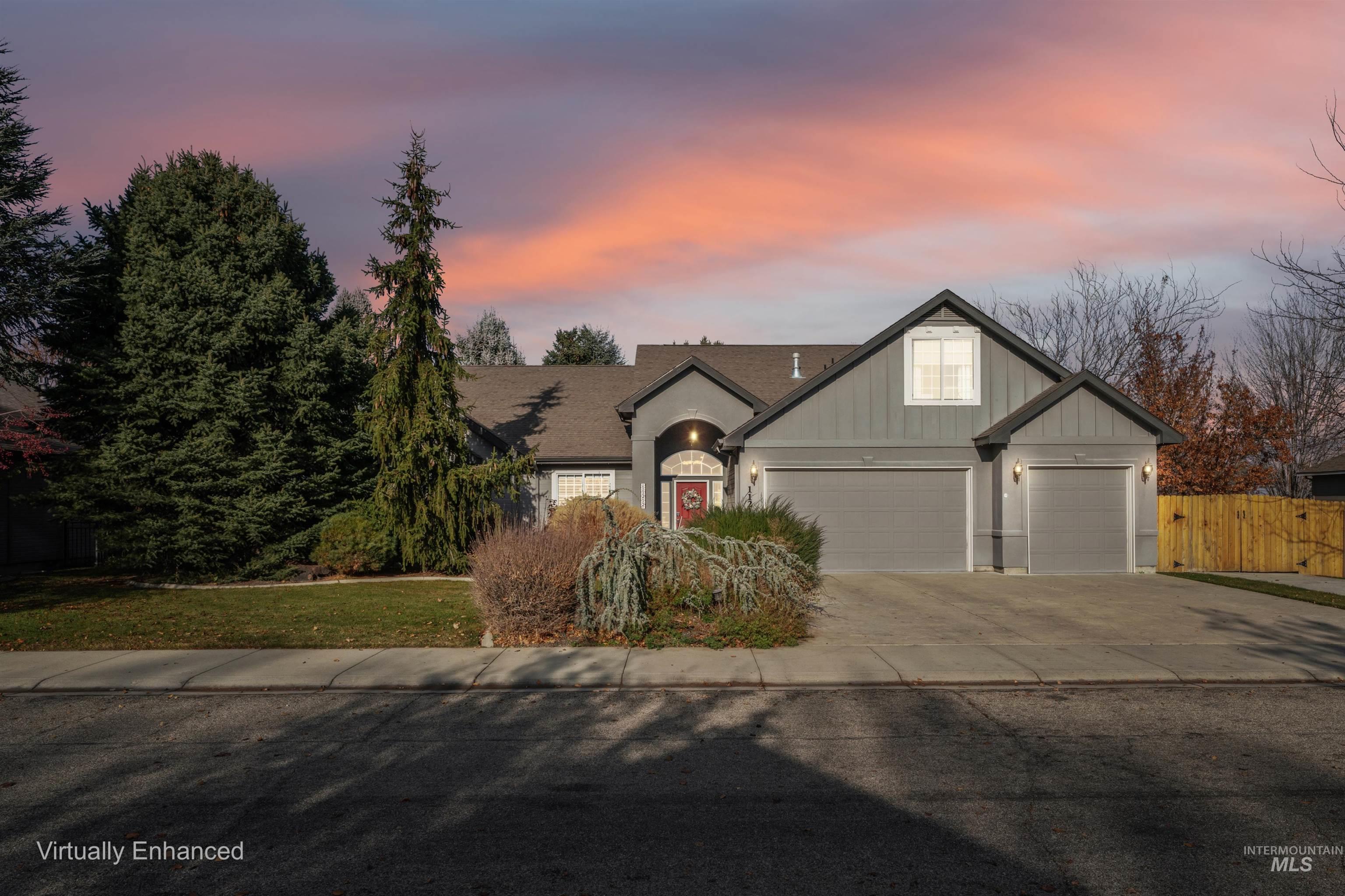 View of front of house with concrete driveway and an attached garage
