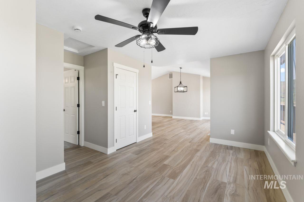 Empty room featuring ceiling fan and light wood-type flooring