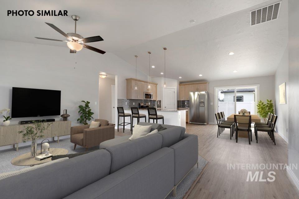 Living area with vaulted ceiling, recessed lighting, light wood-type flooring, and a ceiling fan