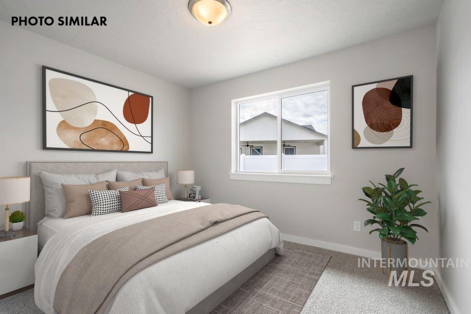 Bedroom featuring carpet flooring and baseboards