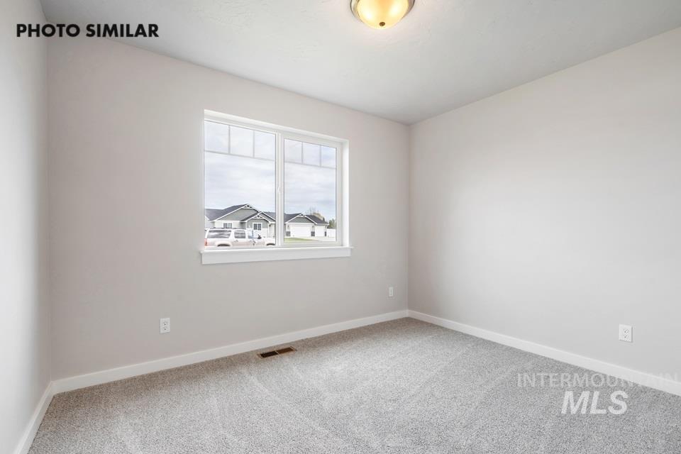 Empty room featuring carpet floors and baseboards