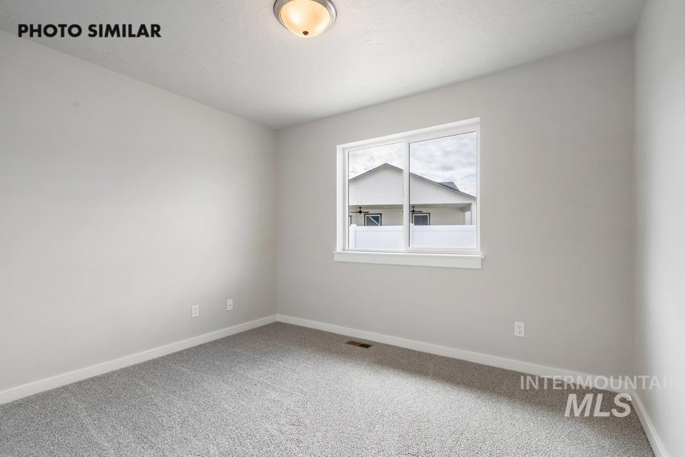 Unfurnished room with carpet and baseboards