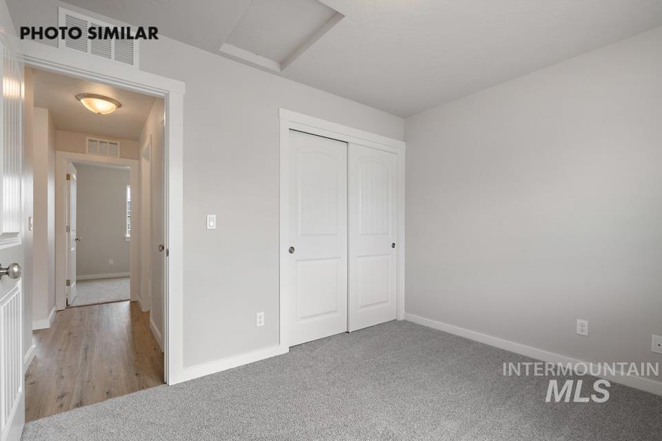 Unfurnished bedroom featuring carpet and a closet