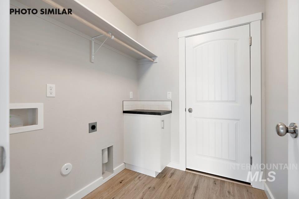 Laundry area featuring electric dryer hookup, light wood-style flooring, gas dryer hookup, and hookup for a washing machine