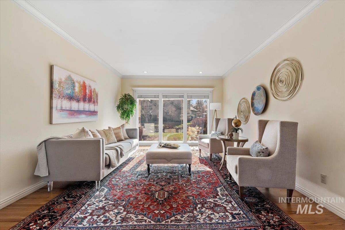 Living area featuring crown molding and wood finished floors