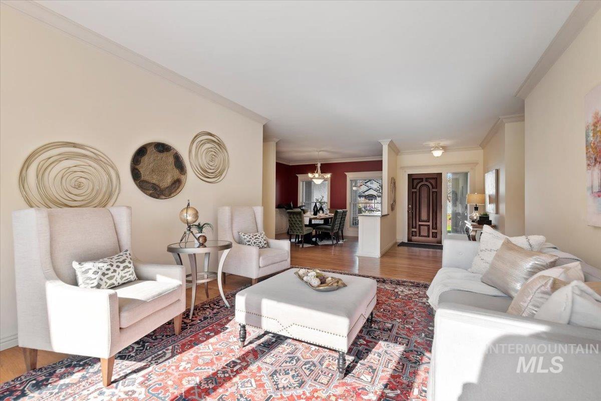 Living room featuring ornamental molding and wood finished floors