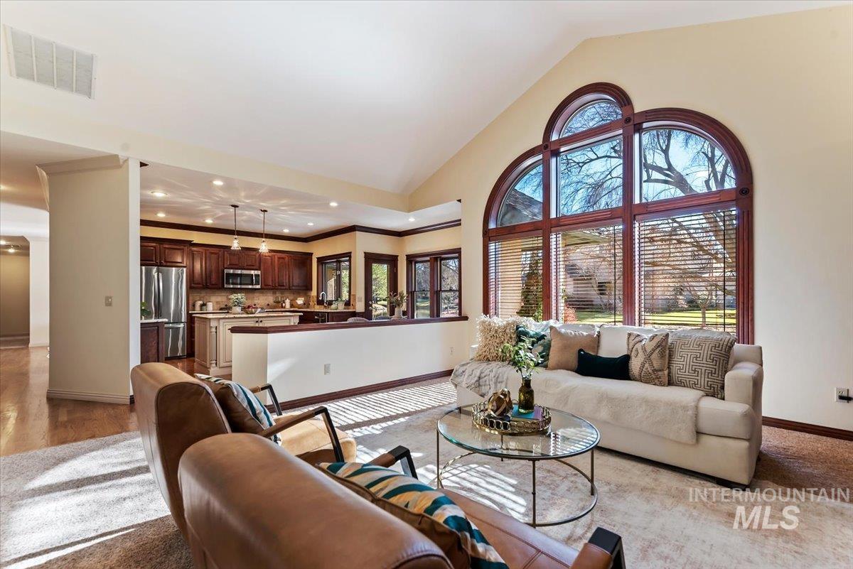 Carpeted living room featuring lofted ceiling and recessed lighting