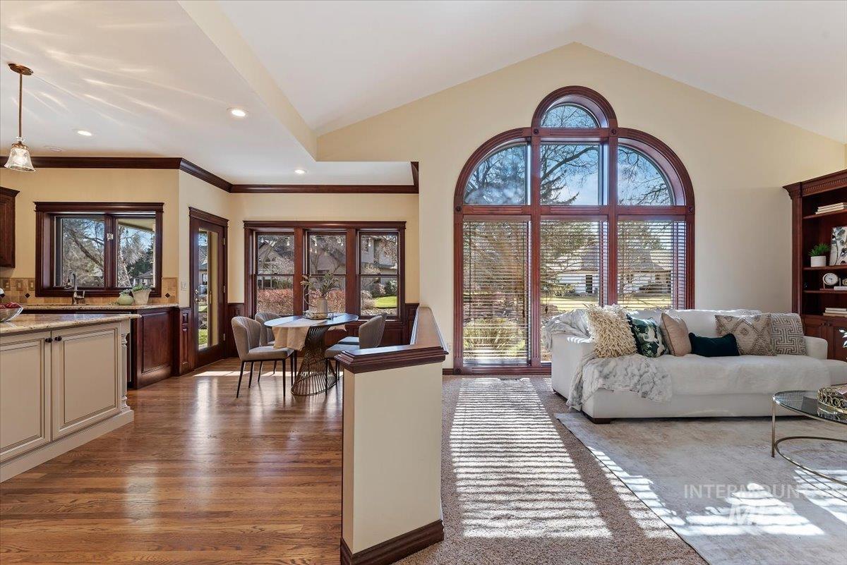 Living room featuring dark wood-style flooring and crown molding