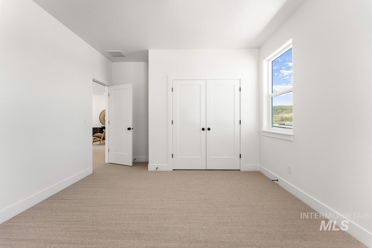 Neutral-toned carpeting complementing white walls and trim