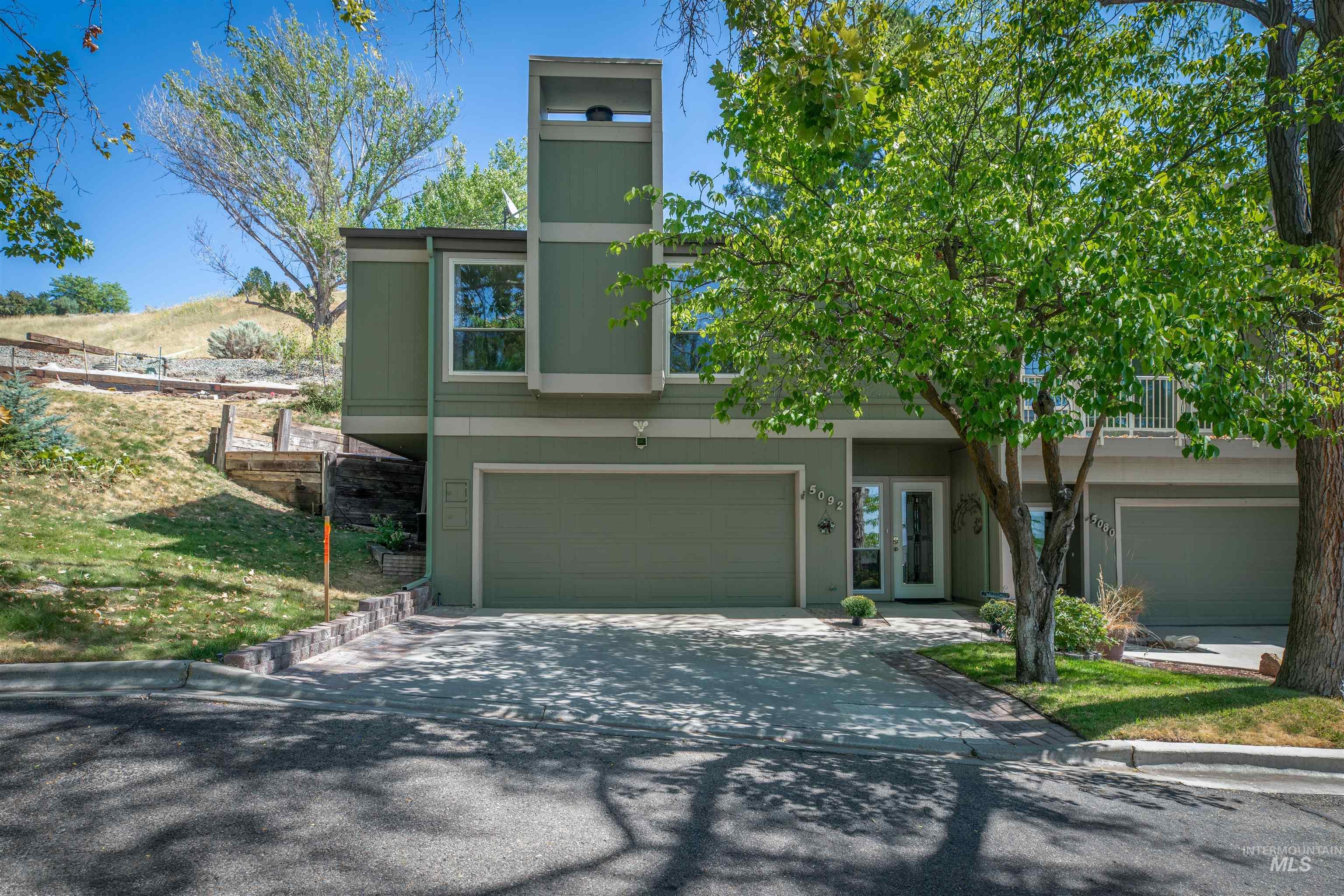 View of front of house featuring driveway and an attached garage