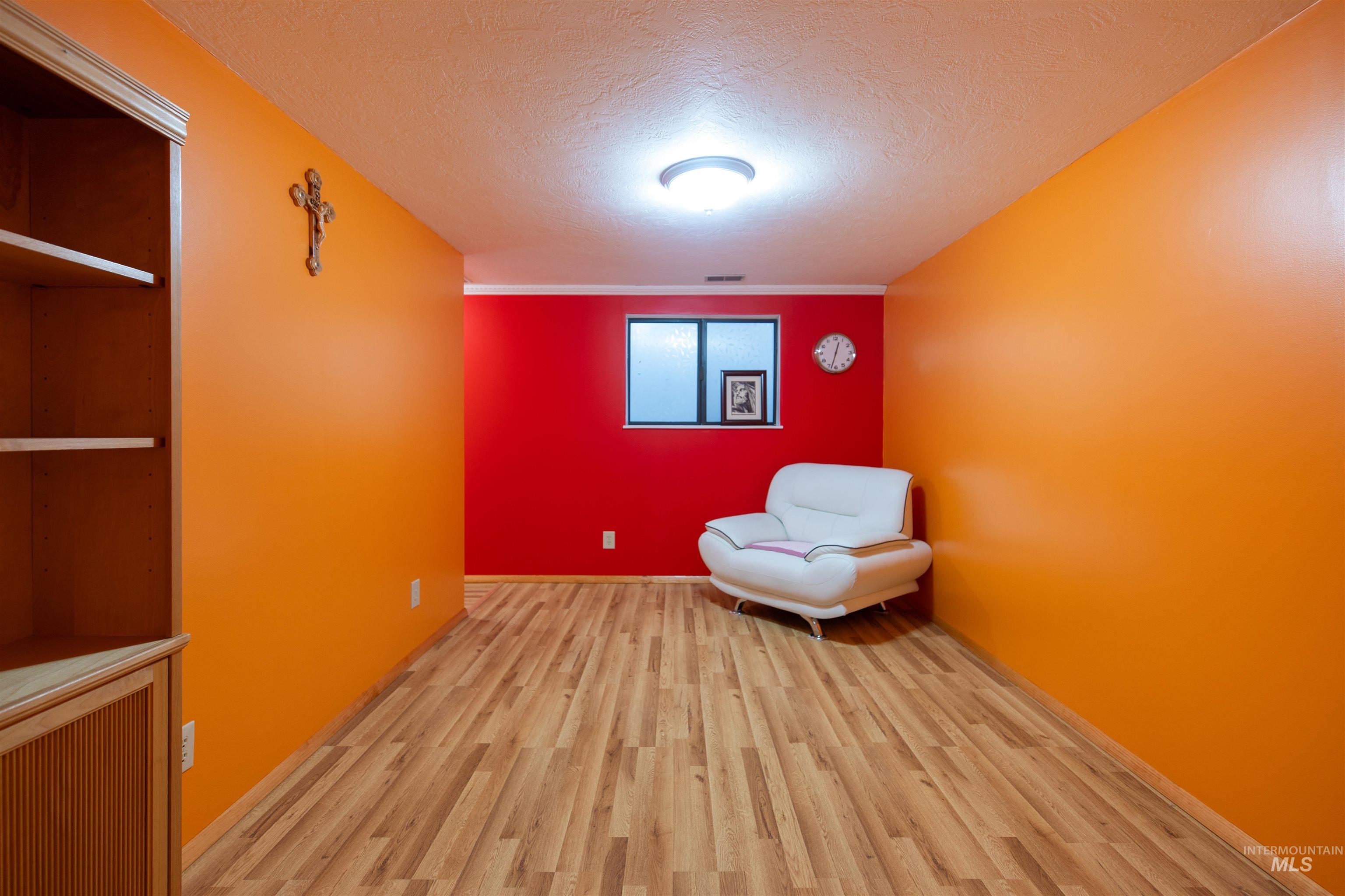 Living area featuring a textured ceiling and wood finished floors