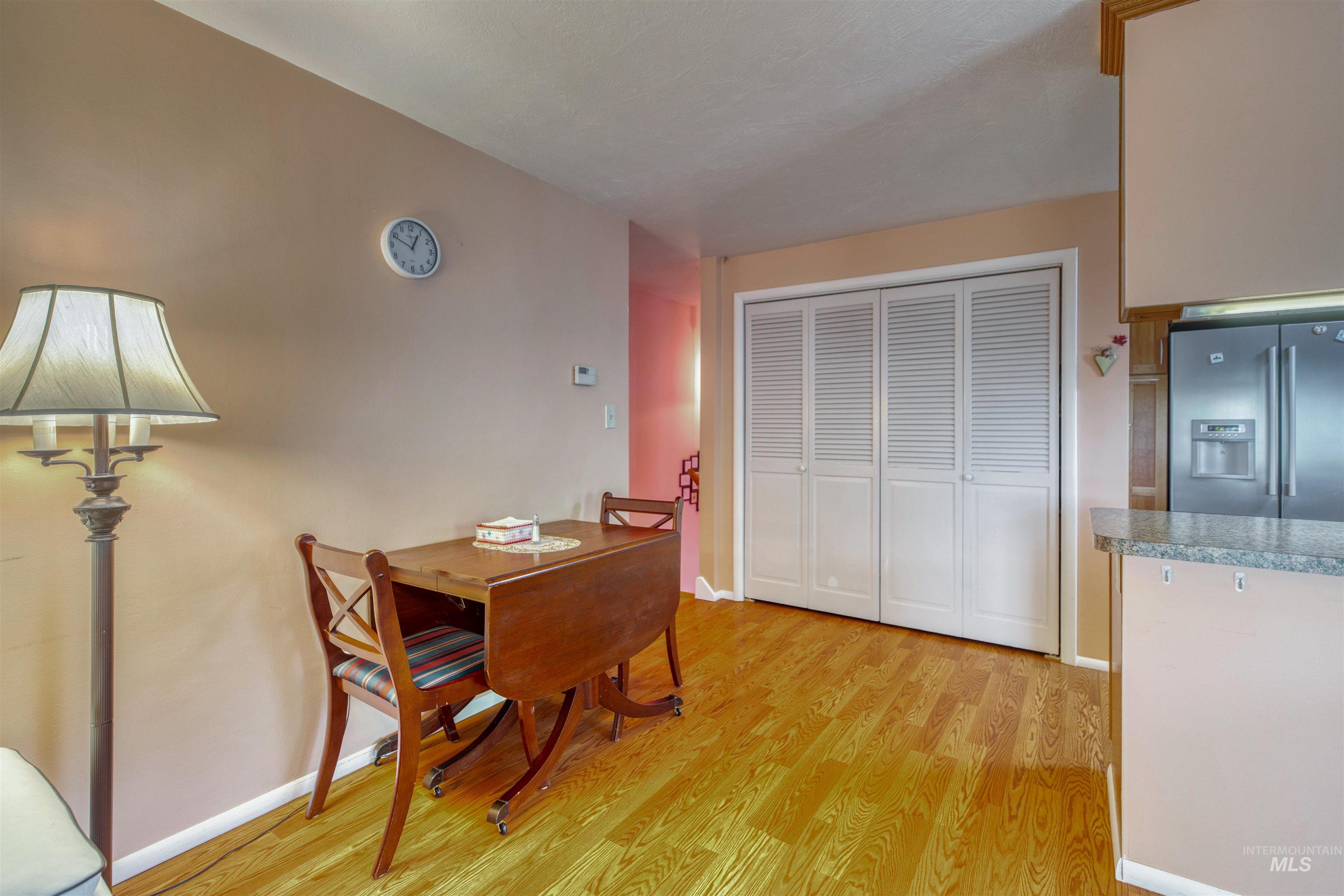 Dining space with light wood-style flooring and baseboards