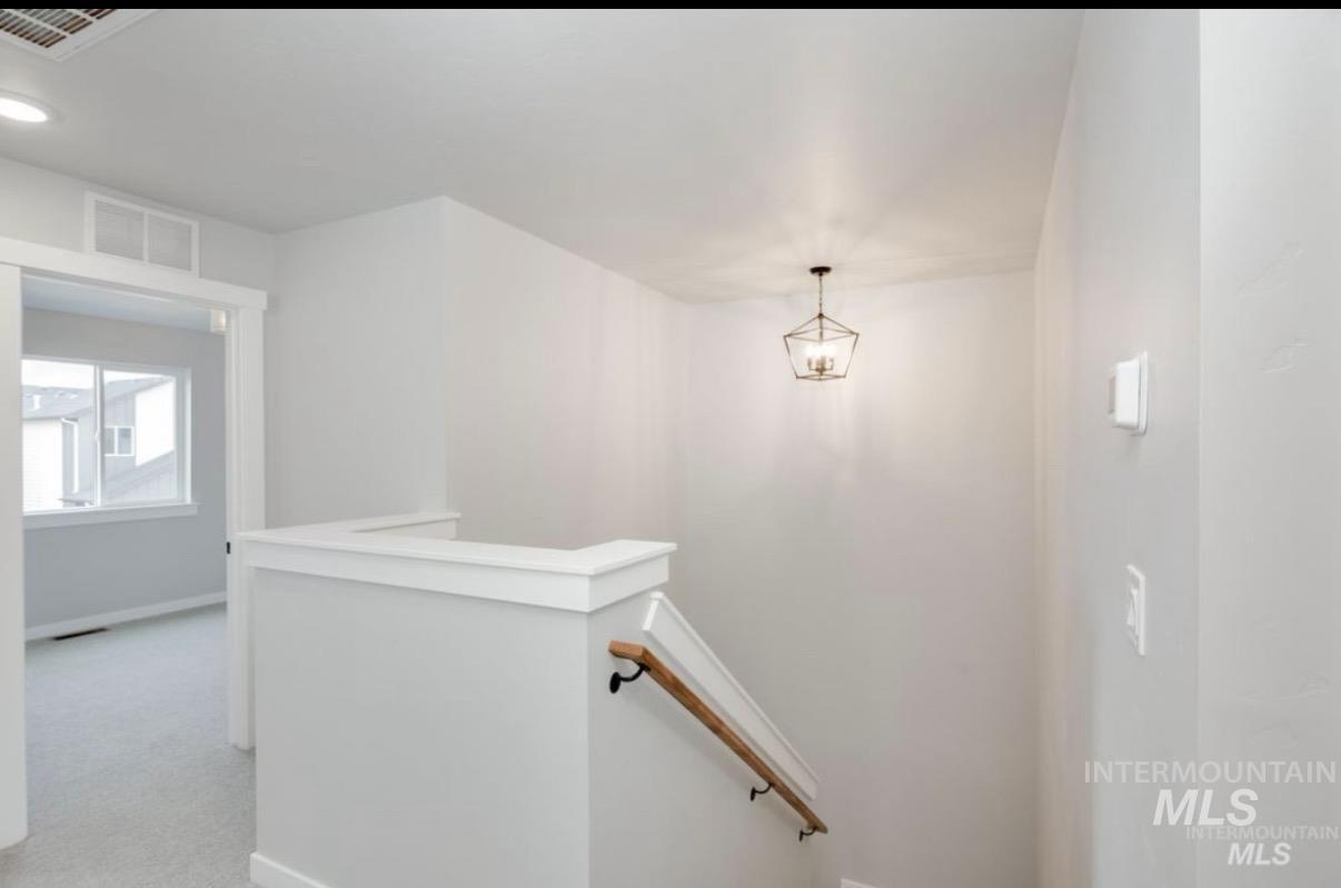 Staircase with baseboards and carpet floors