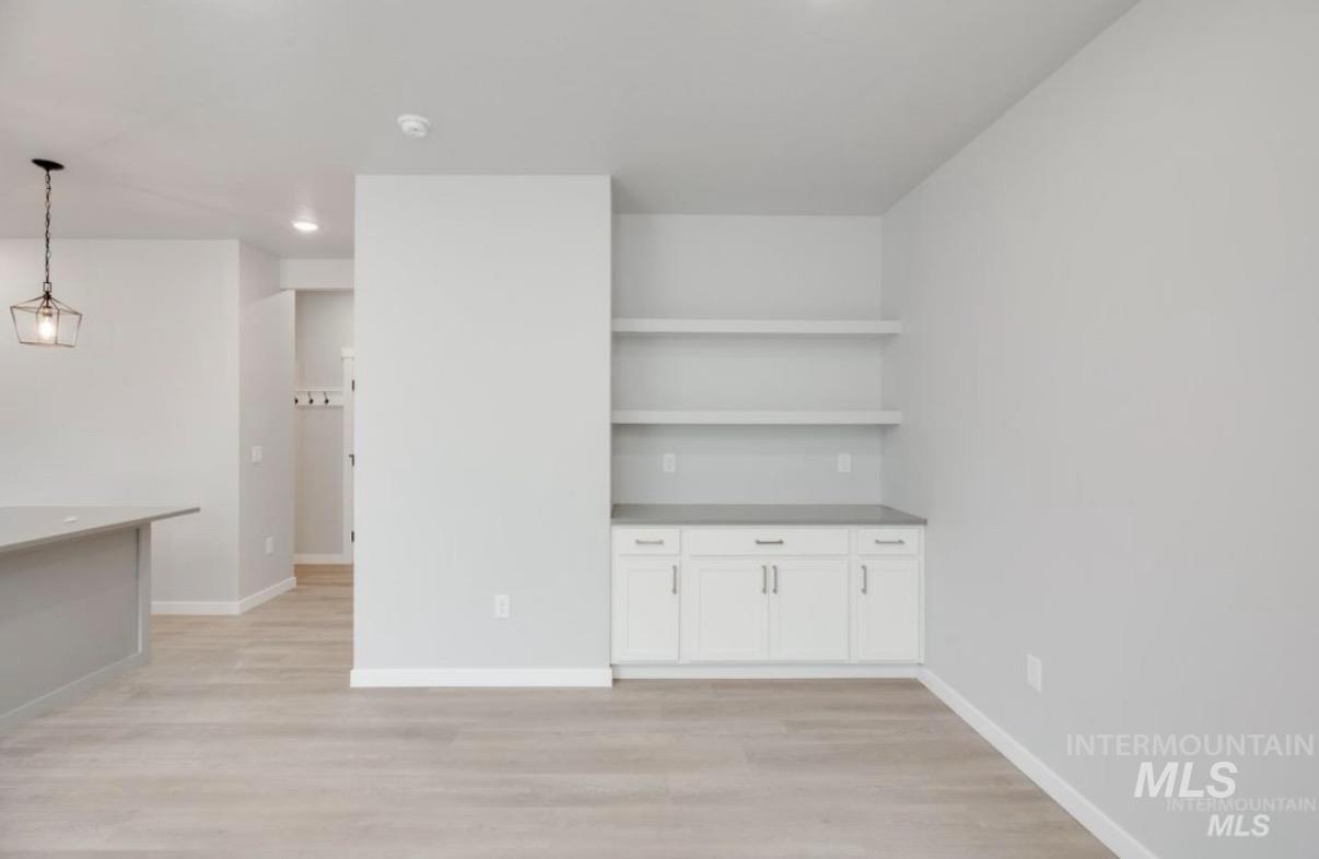 Unfurnished living room with light wood-type flooring and recessed lighting