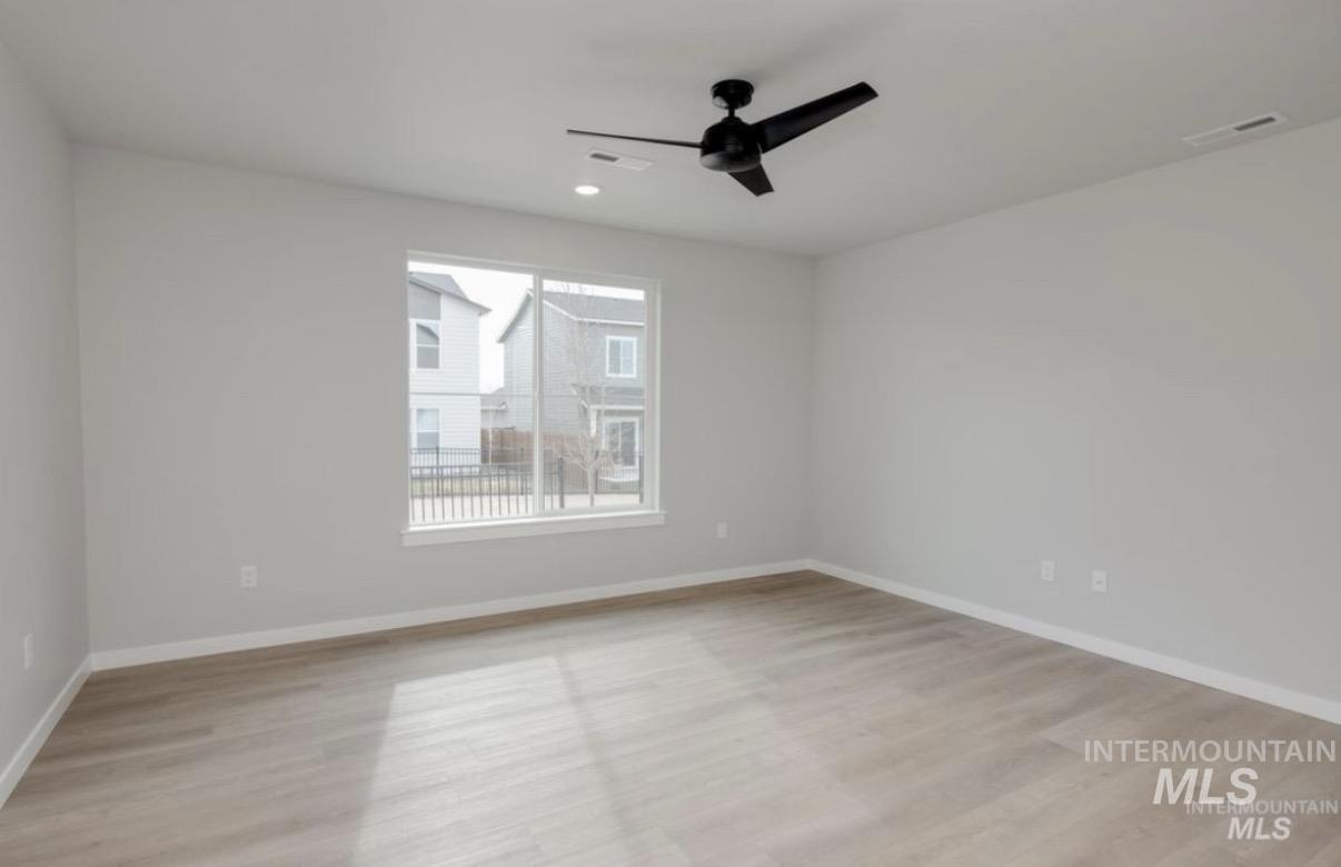 Unfurnished room featuring light wood finished floors, ceiling fan, and recessed lighting