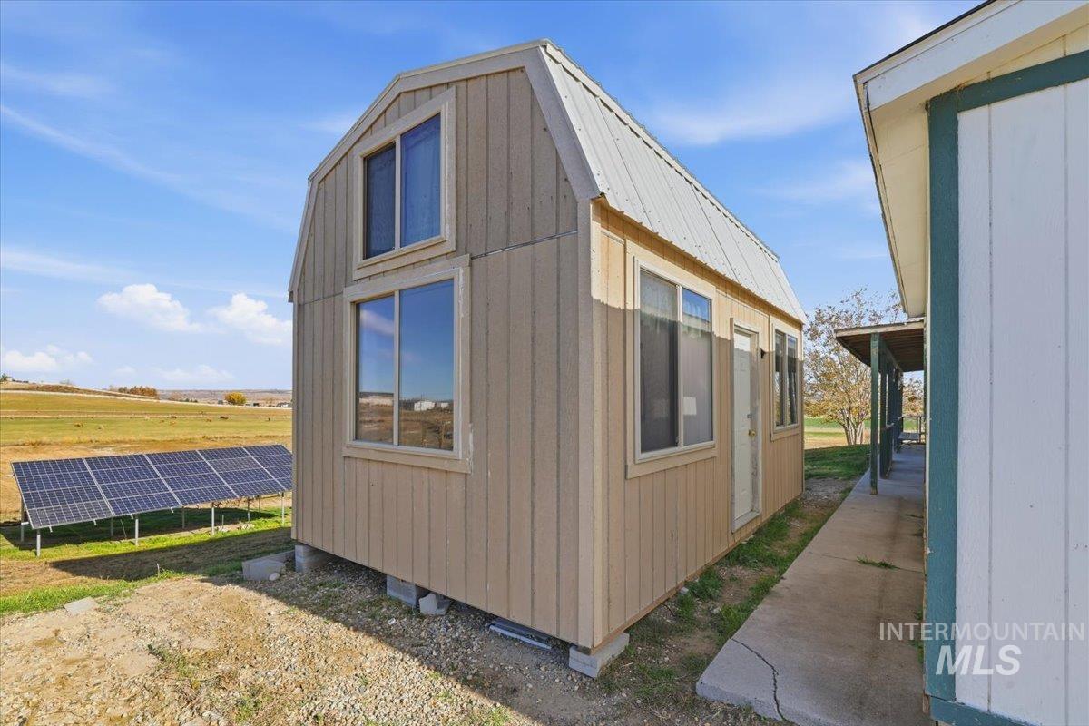 View of outdoor structure featuring solar panels