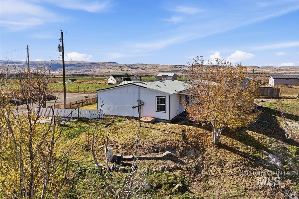 View of side of home featuring a view of countryside and a mountain view