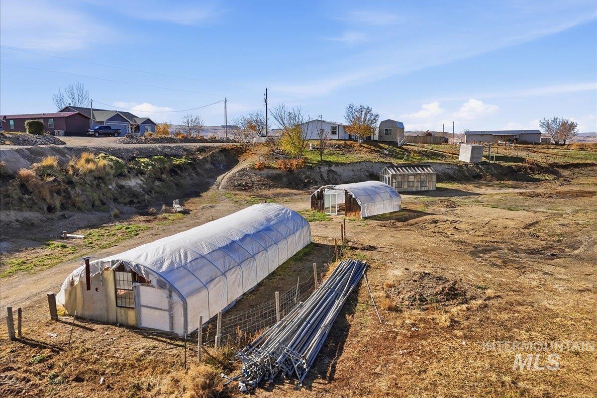 View of home's community featuring a greenhouse and an outbuilding
