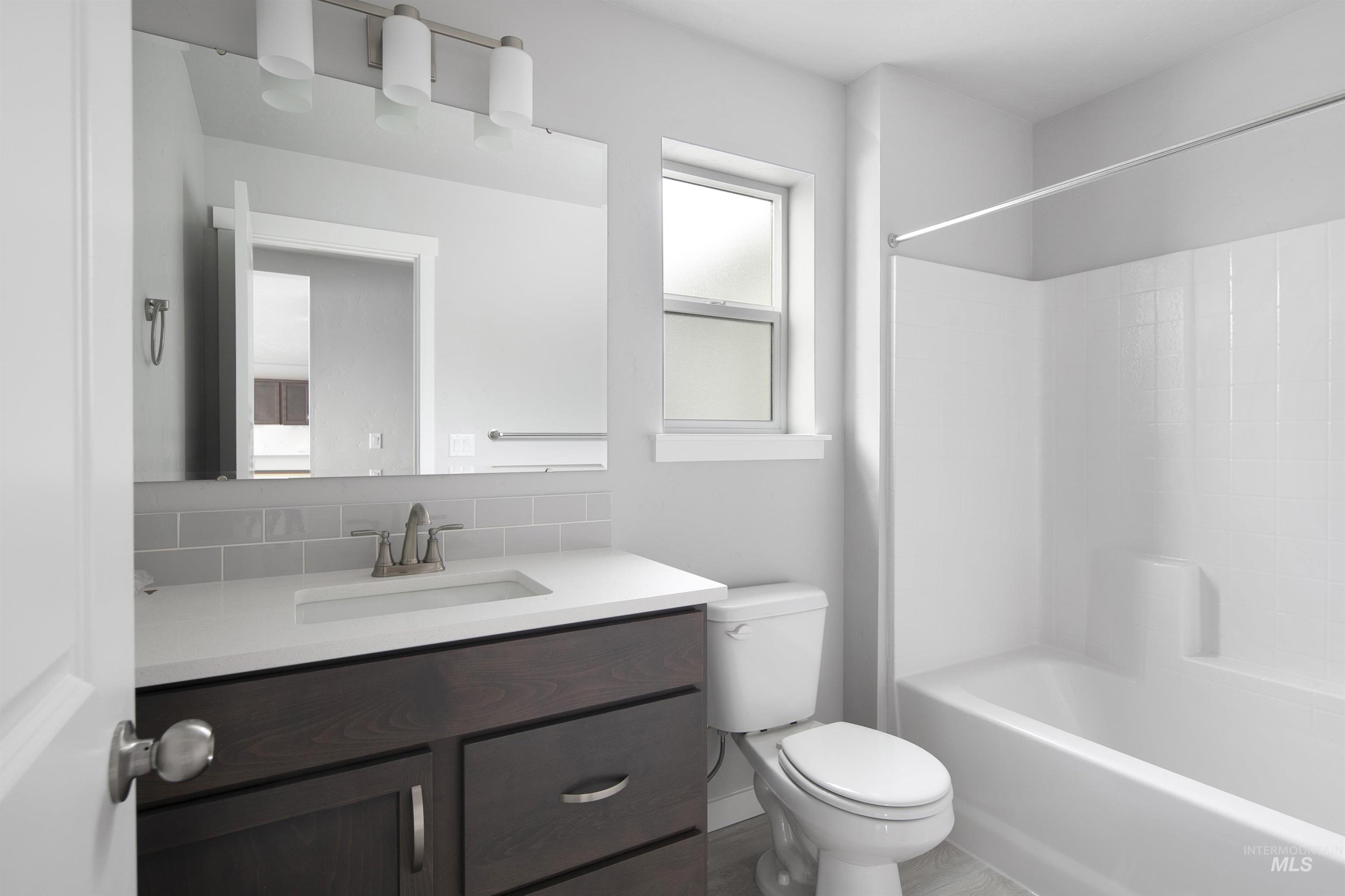 Full bath with vanity and tub / shower combination