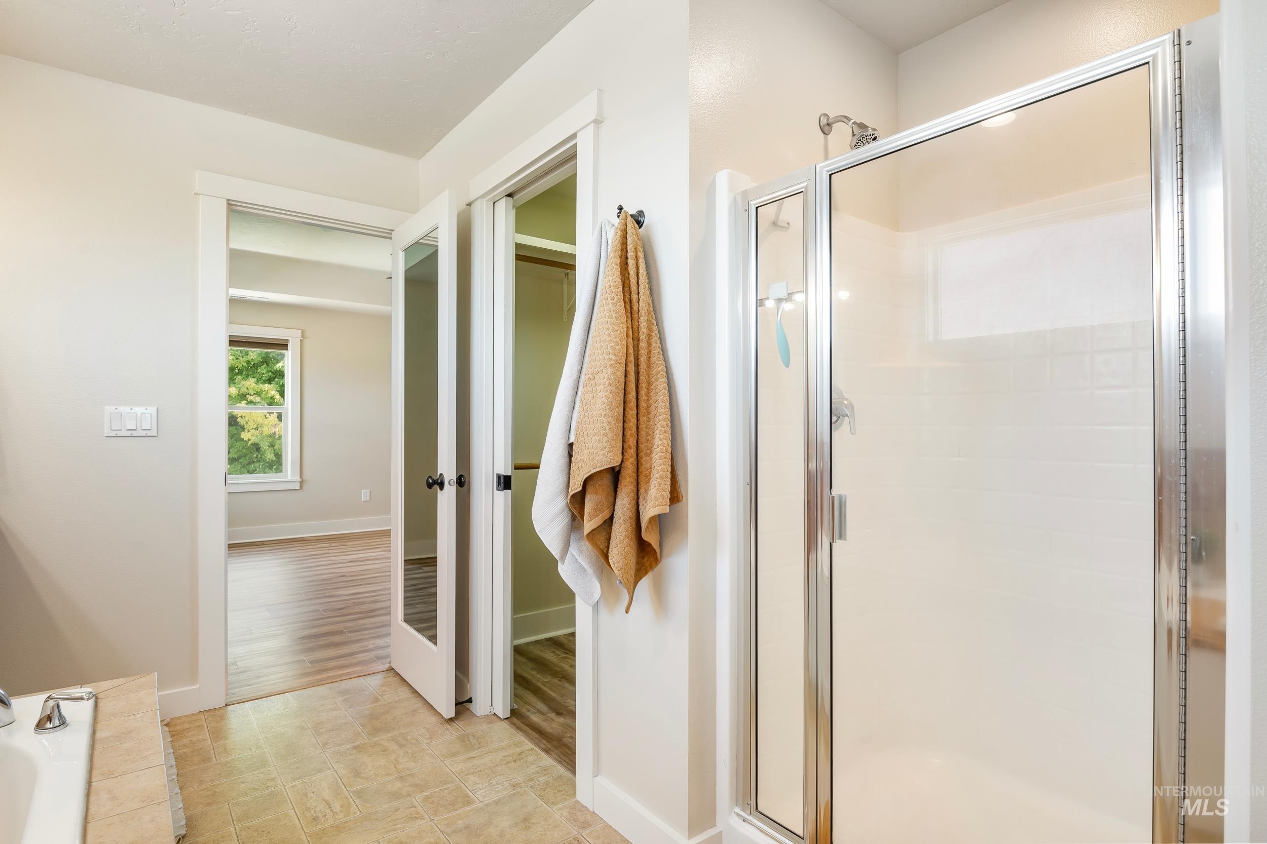 Full bath with a stall shower and a garden tub