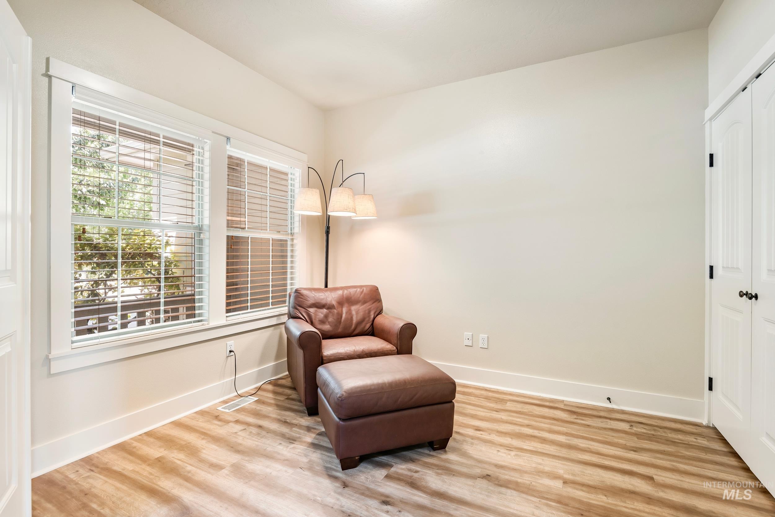 Sitting room with light wood-style floors and baseboards