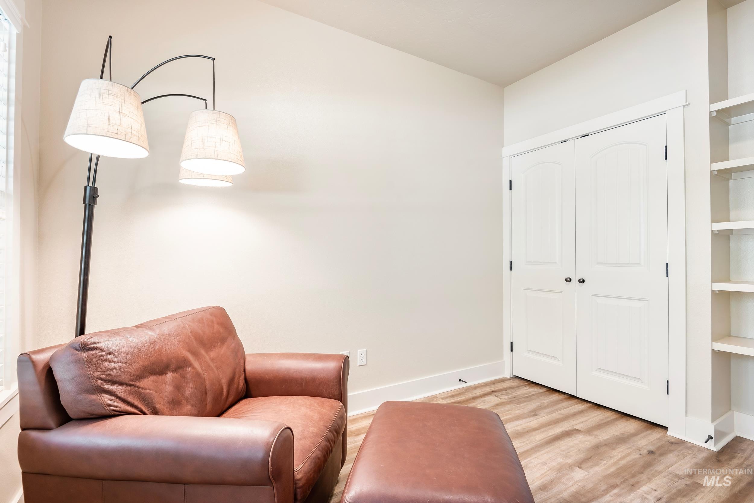 Living area featuring light wood-type flooring and baseboards