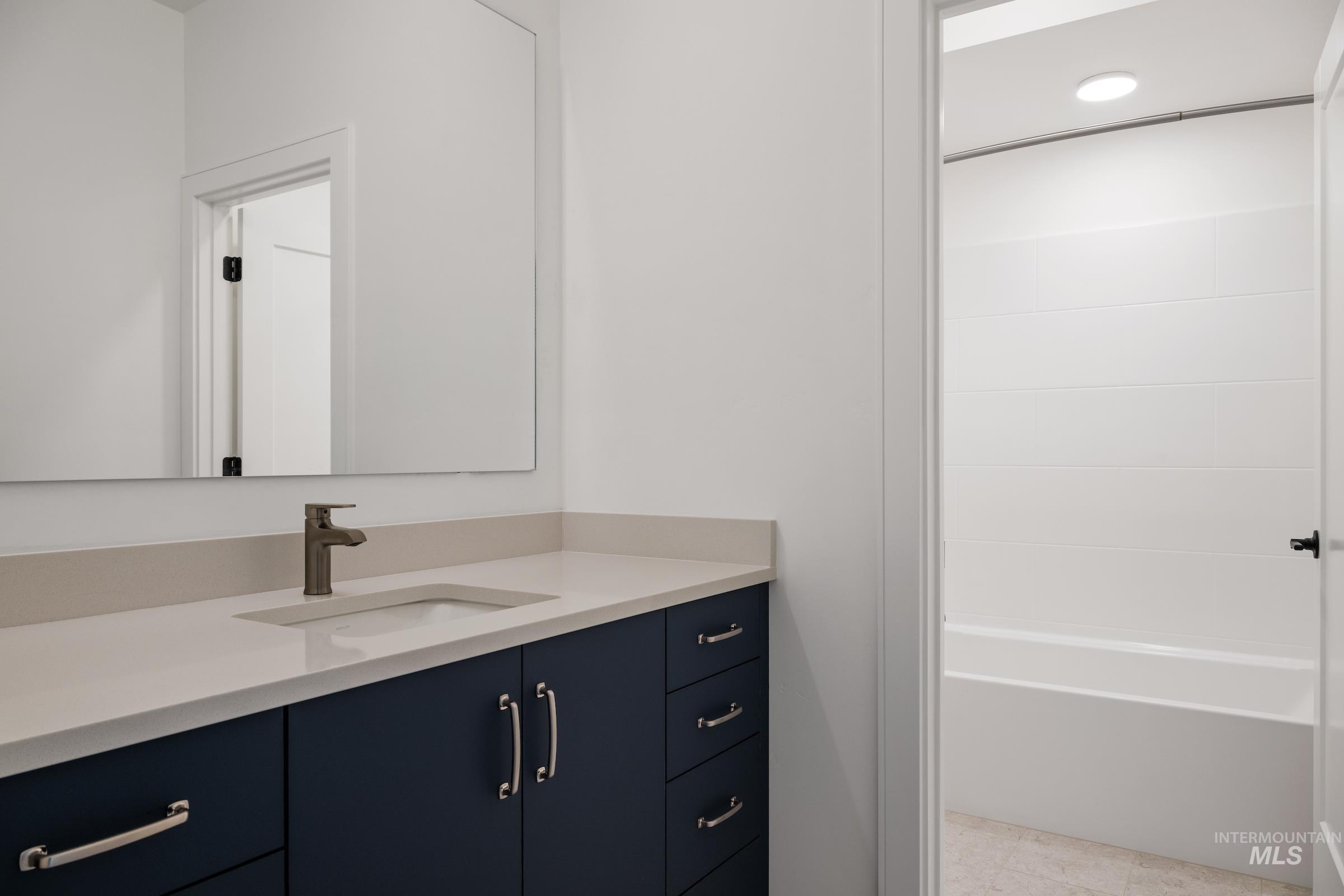 Full bath with vanity and shower / tub combination