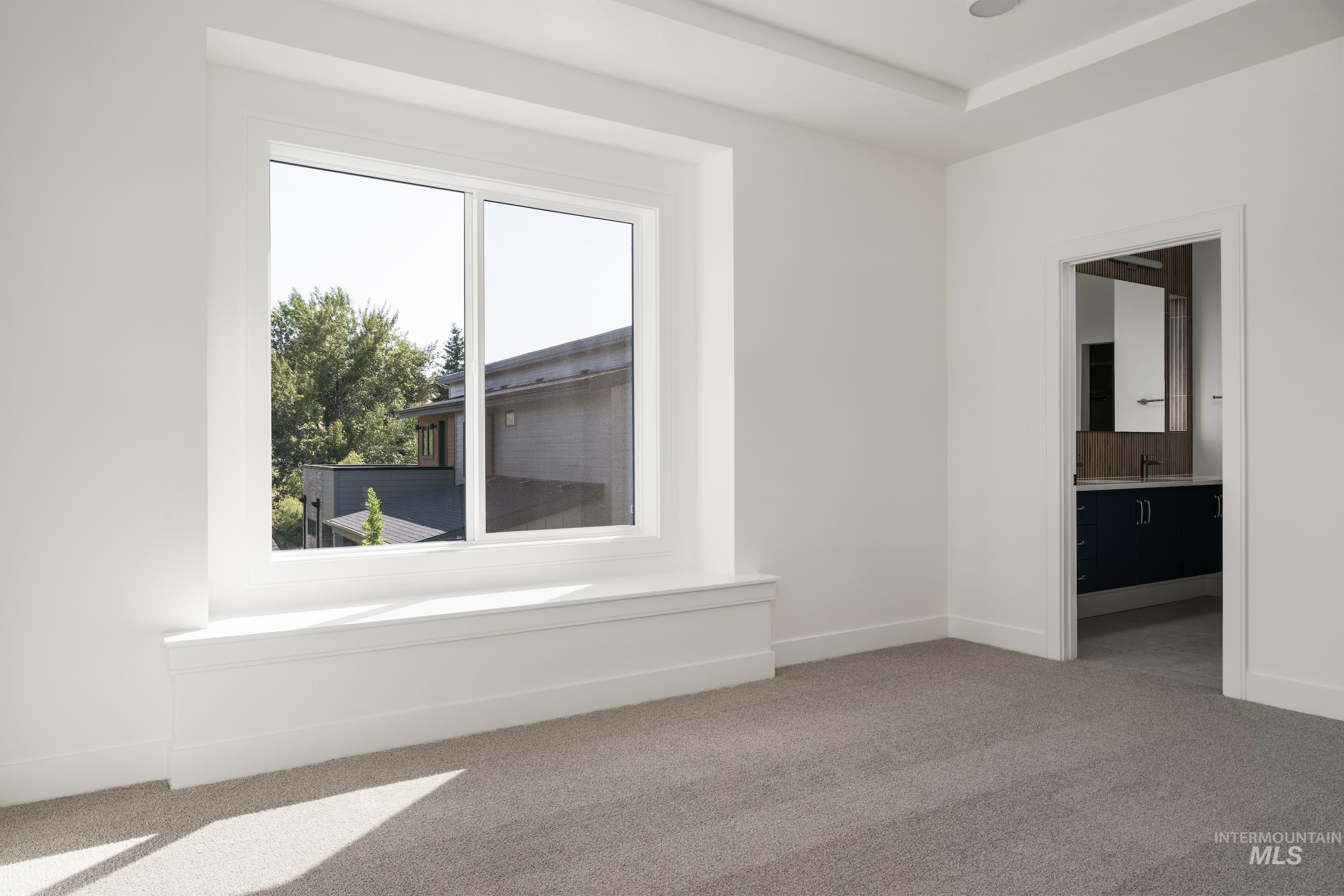 Unfurnished room with healthy amount of natural light and carpet flooring