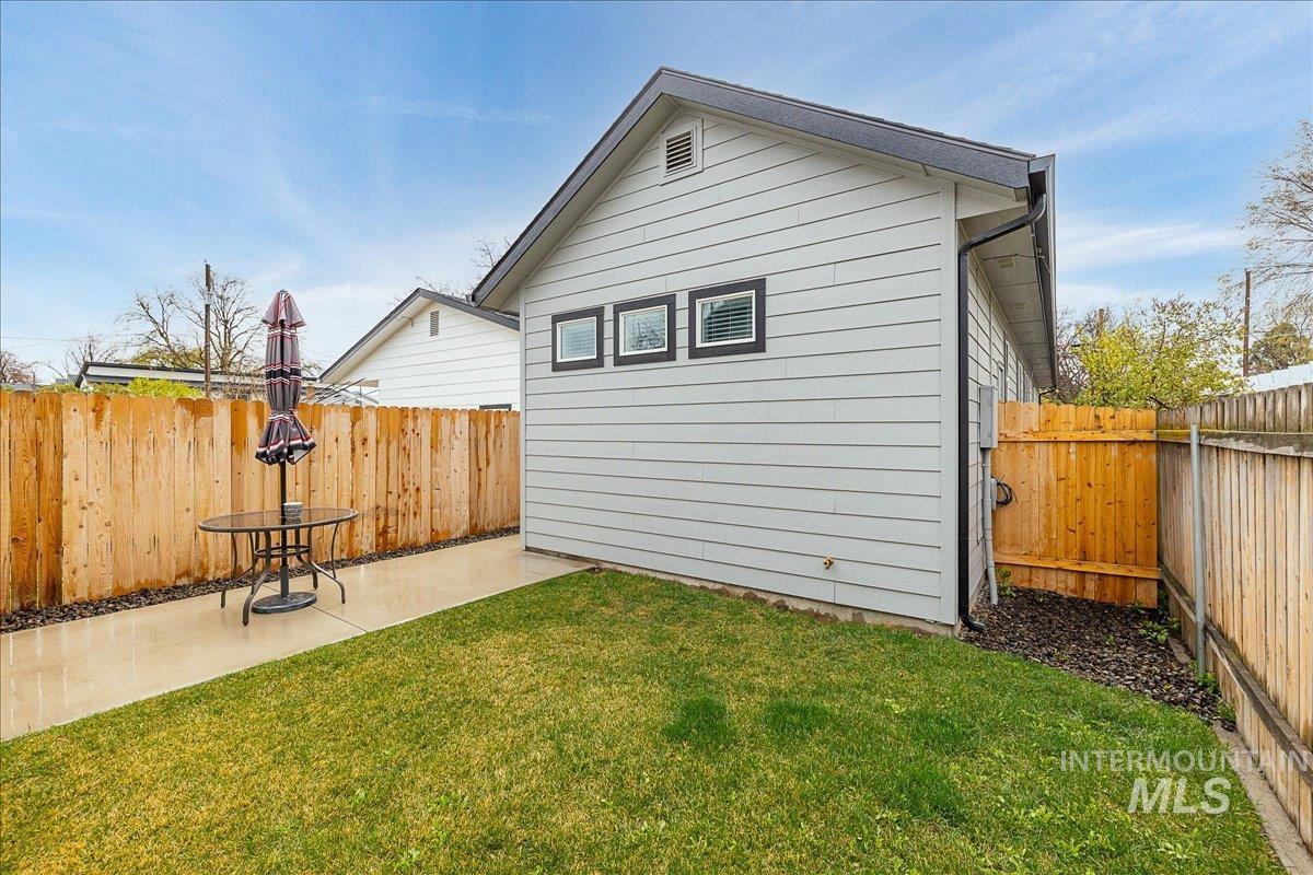 Fenced backyard with a patio area